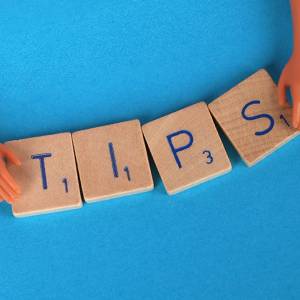 Wooden letter blocks spelling out tips