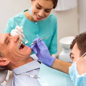 Elderly male patient getting implant-supported dentures