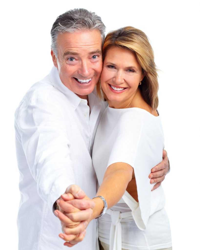 Older couple smiling in a dancing pose
